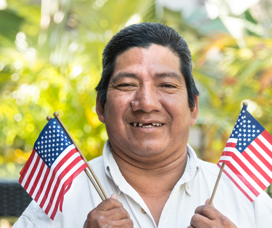 Hispanic man holding American flags